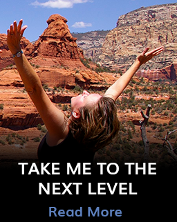 Take me to the next level Woman with arms extended next to mountains with the call to action to take me to the next level