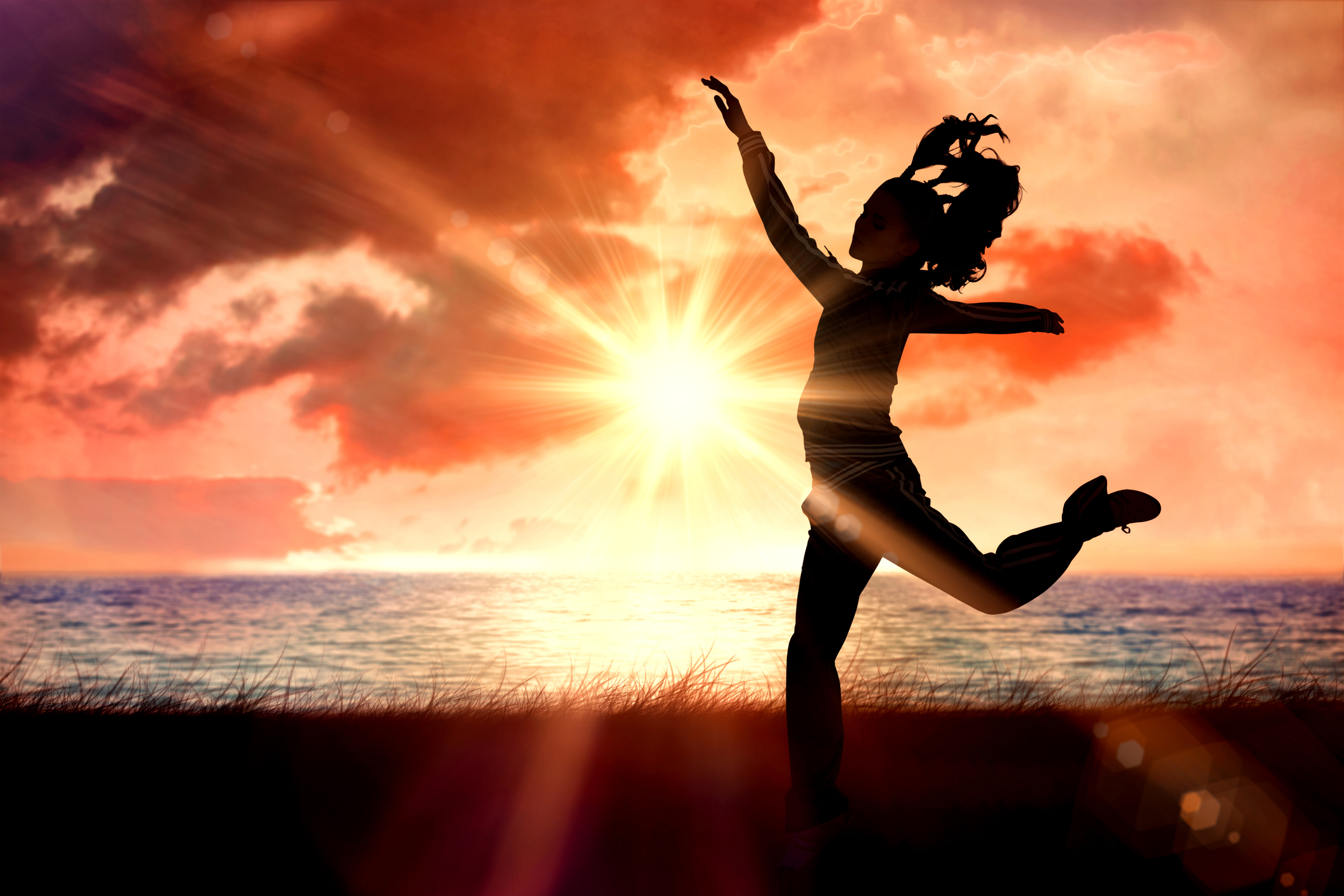 Silhouette view of a woman jumping in the air Silhouette view of a woman jumping in the air
